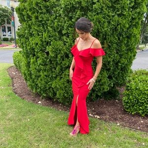 Beautiful red dress with an opening in the leg. 94% polyester, 6% spandex.